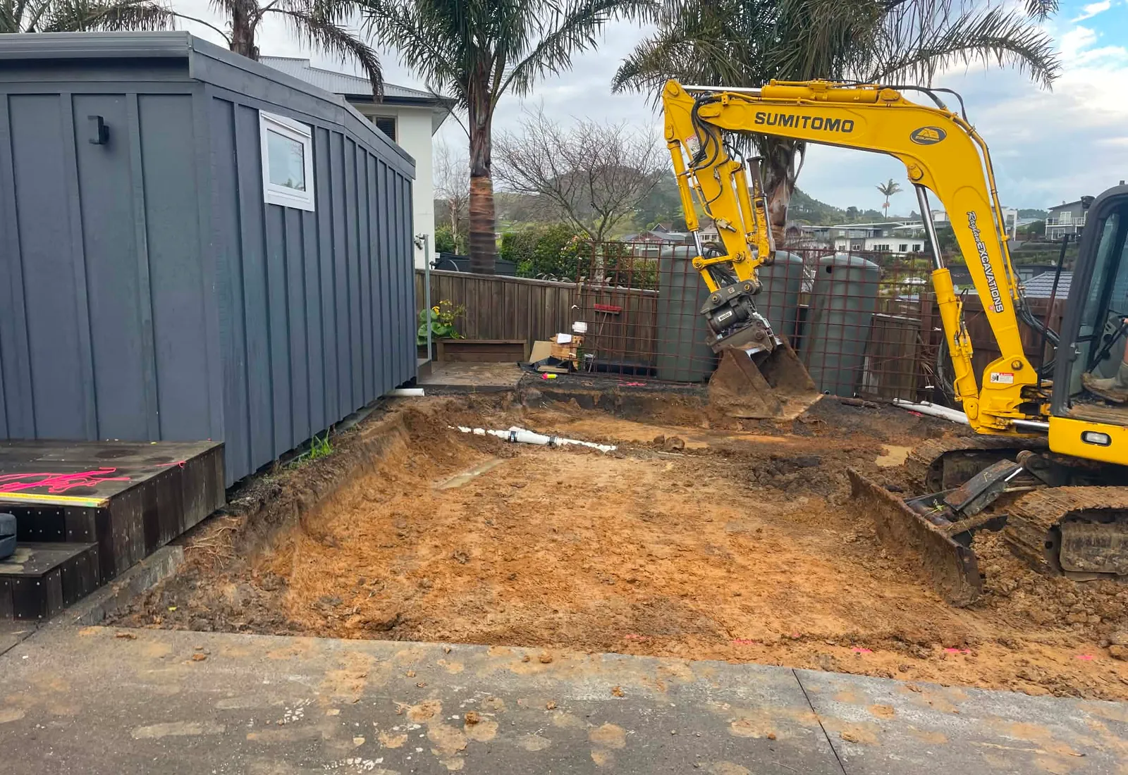Site cut for the new garage slab, with the original house cladding visible at left