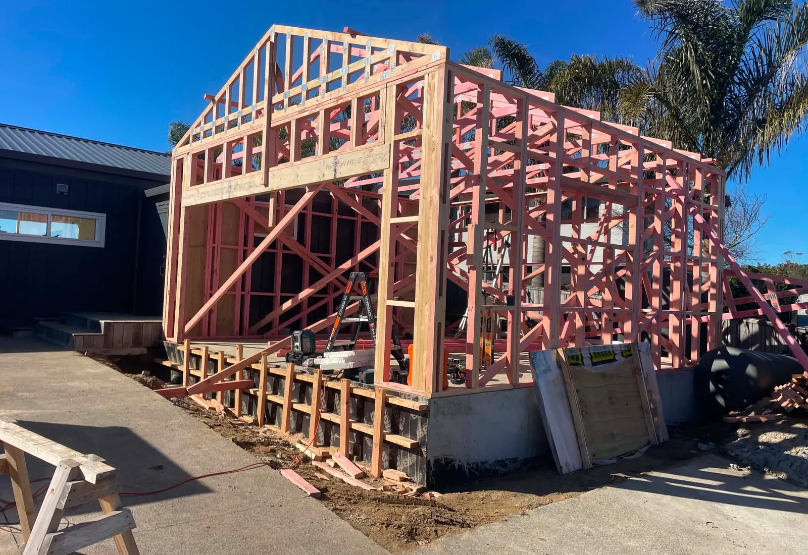 Framing well underway, showing the gable end and the join with the original home