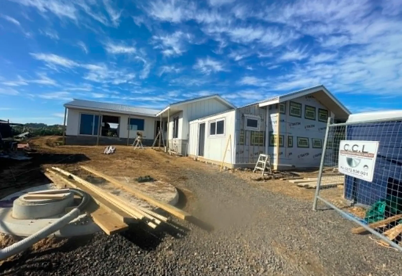 Exterior near completion, with building wrap on the right wing