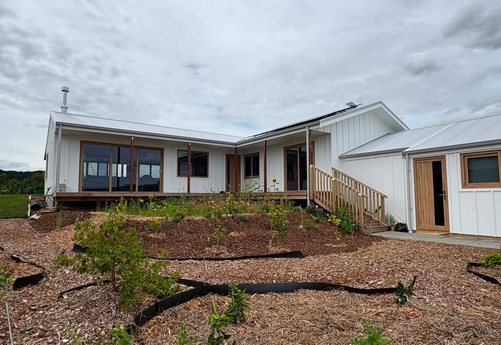 The finished home from a closer angle, showing the deck and entry